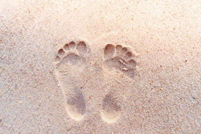 High angle view of heart shape on sand