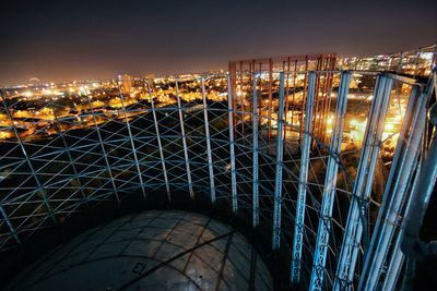 High angle view of illuminated buildings against sky at night