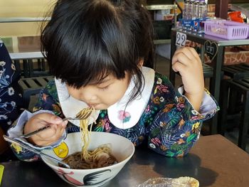 Girl eating food on table