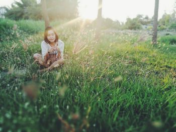 Woman sitting on grass in the park