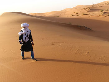 Full length of man on sand dune