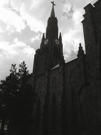 Low angle view of building against cloudy sky