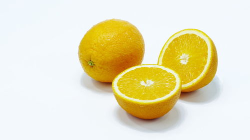 Close-up of orange fruit against white background