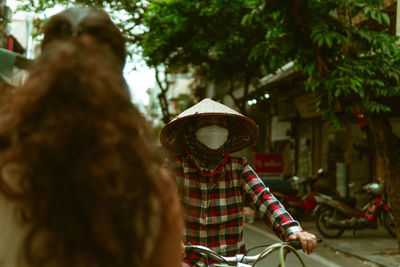 Side view of woman riding bicycle on street