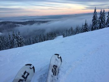 Scenic view of snow covered mountains against sky during sunset