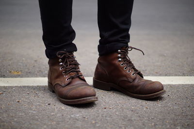 Low section of man standing on street