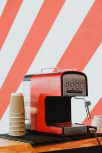 Close-up of telephone booth on table against wall