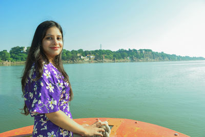 Portrait of beautiful woman against sky