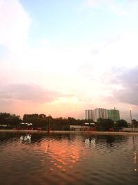 Scenic view of river against sky at sunset