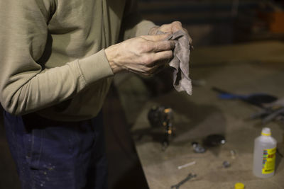 Midsection of man working at workshop