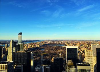 View of cityscape against blue sky