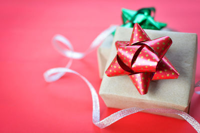Close-up of christmas present on red background