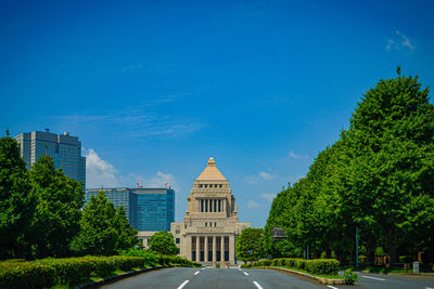 Buildings in city against blue sky