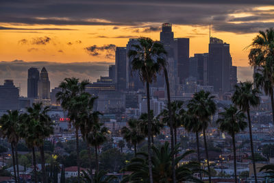 Buildings in city at sunset