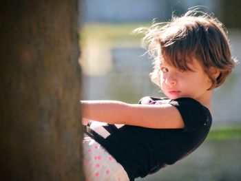 Portrait of cute girl playing while sitting in playground