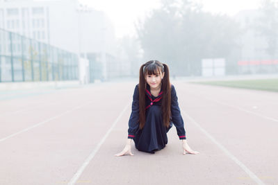 Portrait of a teenage girl standing on road