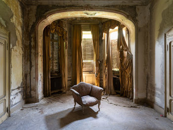 An armchair in an empty room with natural light 