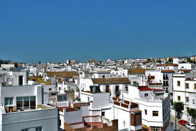 Cityscape against clear blue sky