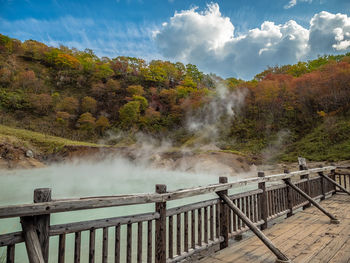 Scenic view of waterfall against sky