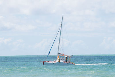 Boat sailing in sea against sky