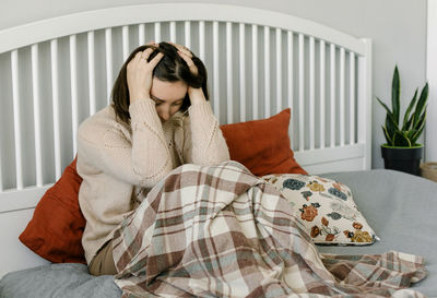 Young woman sleeping on bed at home