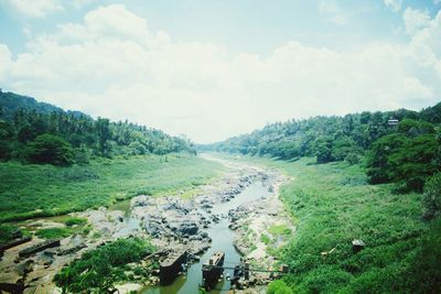 Scenic view of landscape against cloudy sky