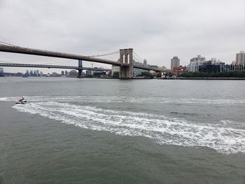 View of bridge over sea against cloudy sky