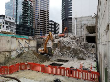 Buildings by construction site in city