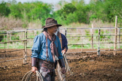 Cowboy holding rope at beach