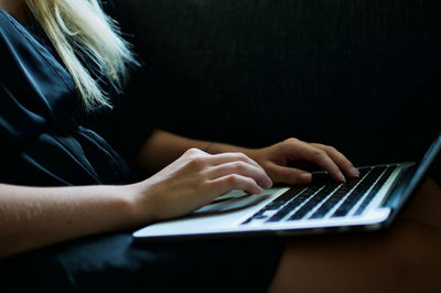 Midsection of woman using mobile phone