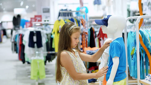 Shopping in the store. children's clothing department. girl, kid, chooses things in the store.