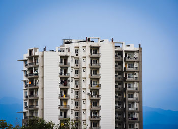 Low angle view of buildings against blue sky