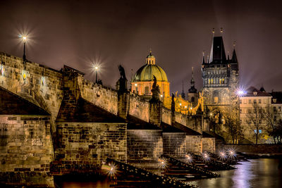 Illuminated bridge against sky at night