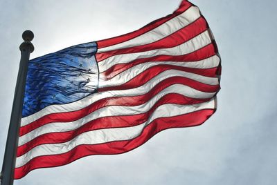 Low angle view of flag against sky