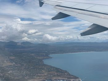 Aerial view of sea and mountains against sky