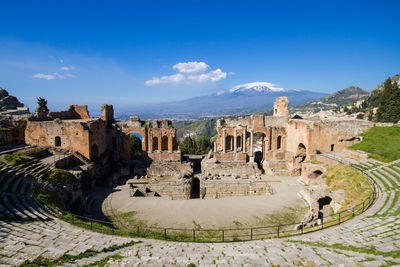 Panoramic view of old ruins against blue sky during sunny day