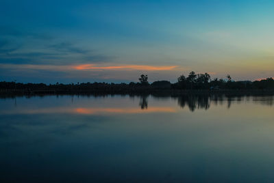 Scenic view of calm lake at dusk