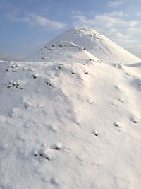 Low angle view of snowcapped mountain against sky