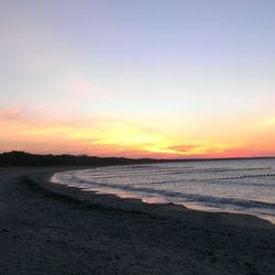 Scenic view of beach at sunset