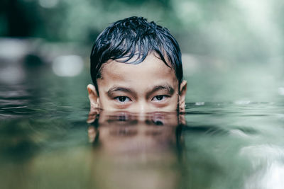 Portrait of man swimming in pool