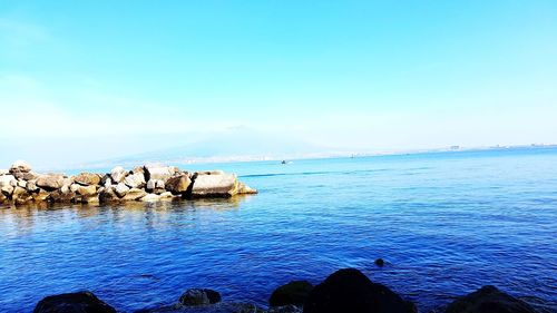 Scenic view of sea against blue sky