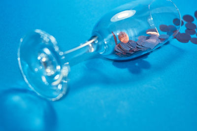 High angle view of blue drinking glass on table