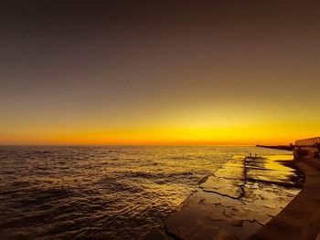 Scenic view of sea against clear sky during sunset