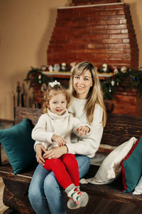 Portrait of smiling young woman sitting on steps