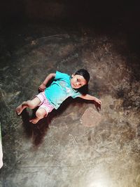 High angle view of woman lying down on floor