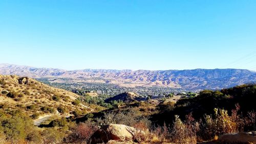 Scenic view of mountains against clear blue sky