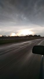 Car on road against sky during sunset