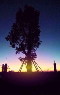 Low angle view of silhouette trees against sky at sunset