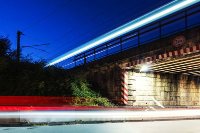 Light trails on railroad station platform at night