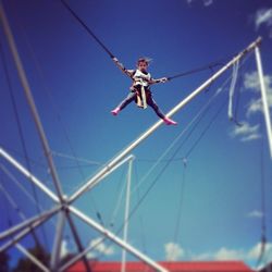 Low angle view of woman jumping